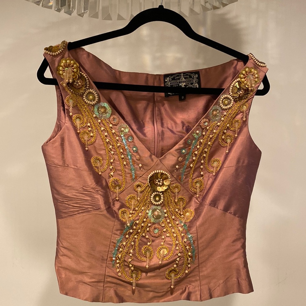Beautiful silk top with heavy beads and details. Never worn with tags. Size 8